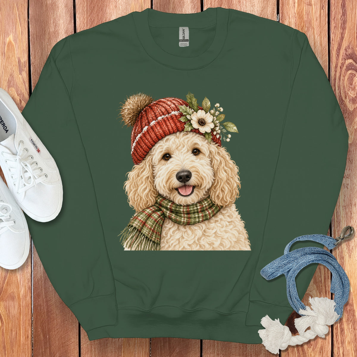 Green sweatshirt with watercolor illustration of a fluffy dog wearing a hat and scarf.
