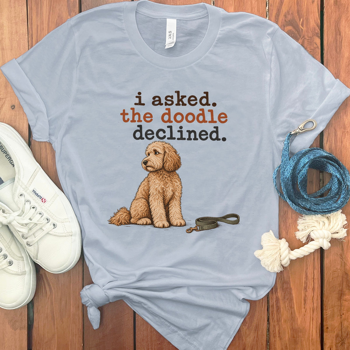 Light blue t-shirt with "i asked. the doodle declined." and a doodle dog illustration.