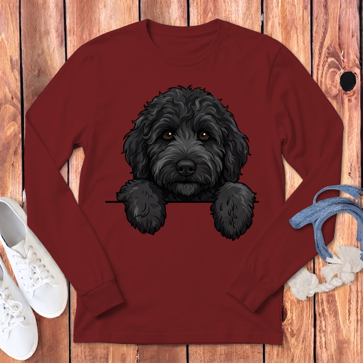 Maroon long-sleeve shirt with a black doodle dog illustration peeking over the front.