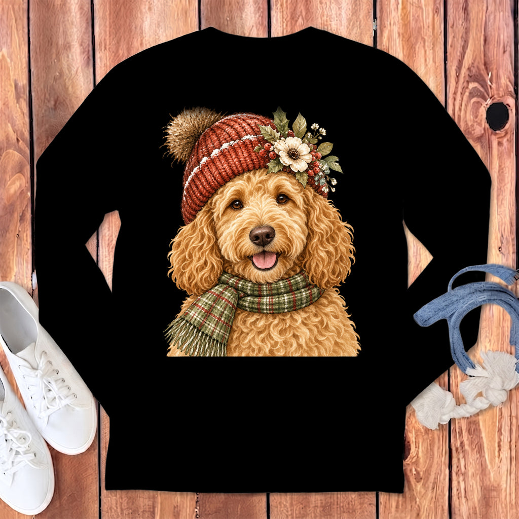 Goldendoodle wearing a red knitted hat and green plaid scarf with floral accents.
