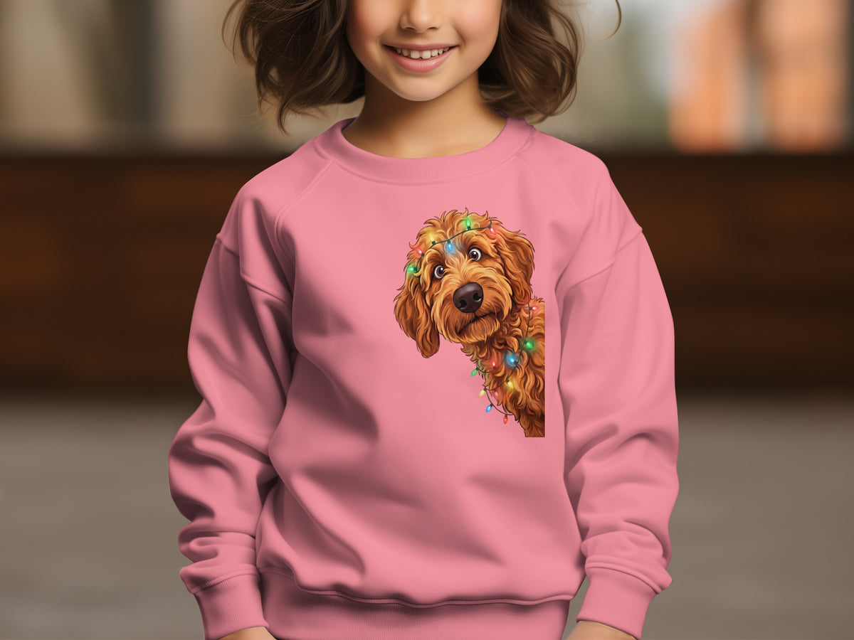 Child wearing pink sweatshirt with cartoon dog and Christmas lights graphic.