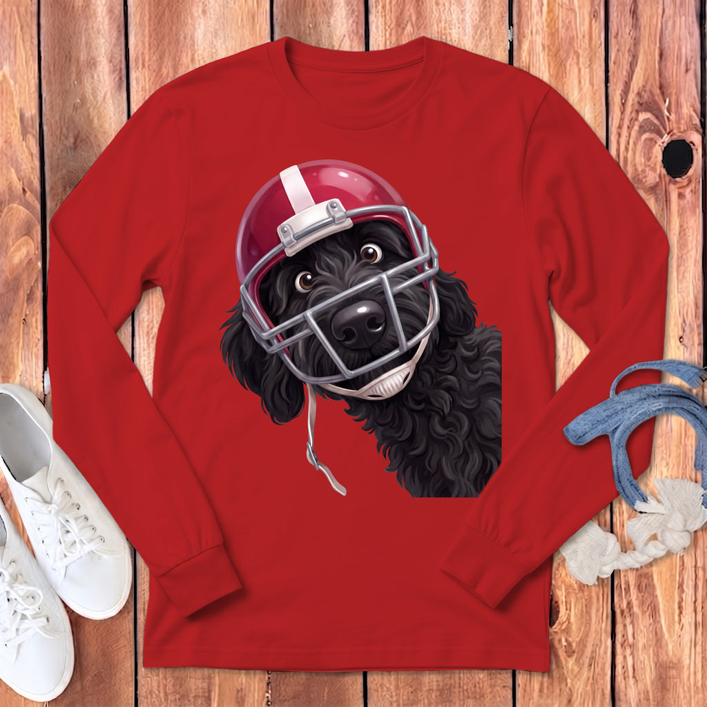 Black dog wearing a red football helmet on a red long-sleeved shirt.