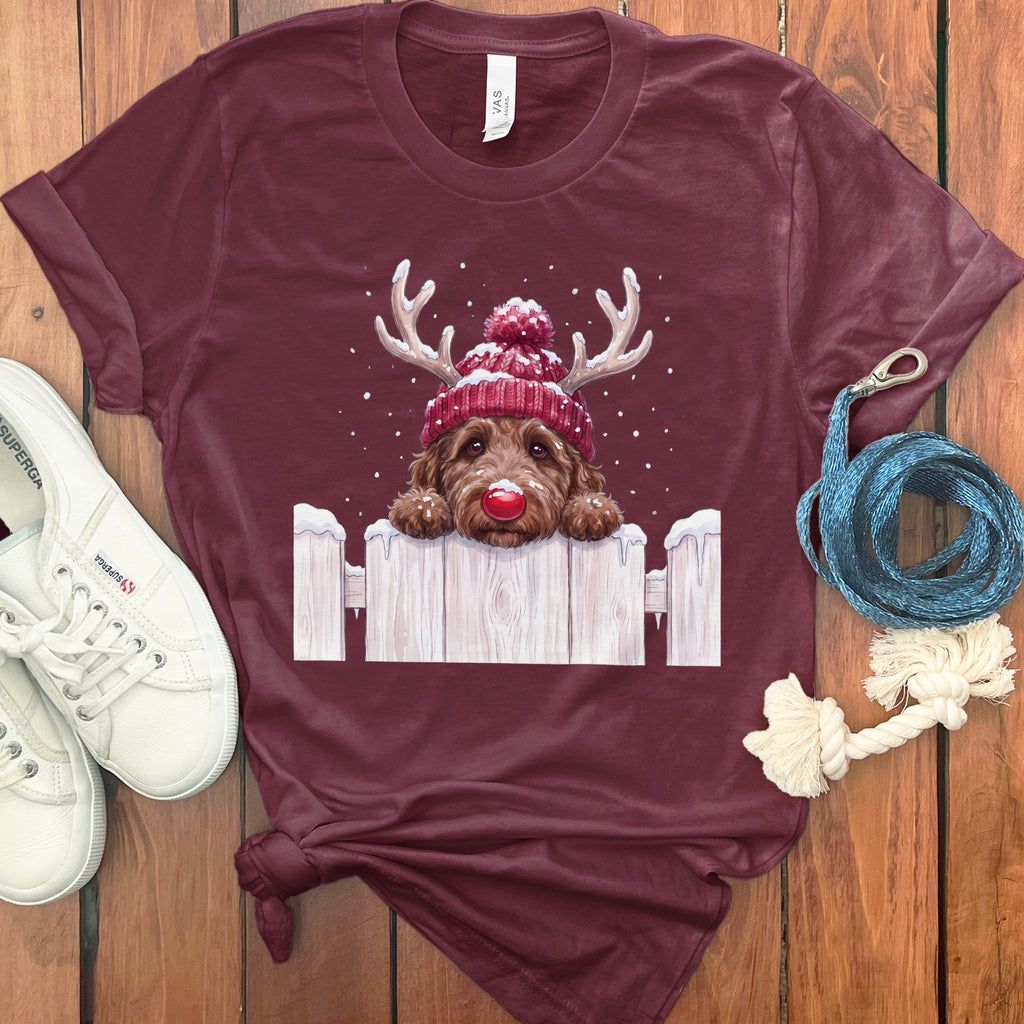 Maroon t-shirt with a dog wearing antlers, a red pom-pom hat, and a red nose.