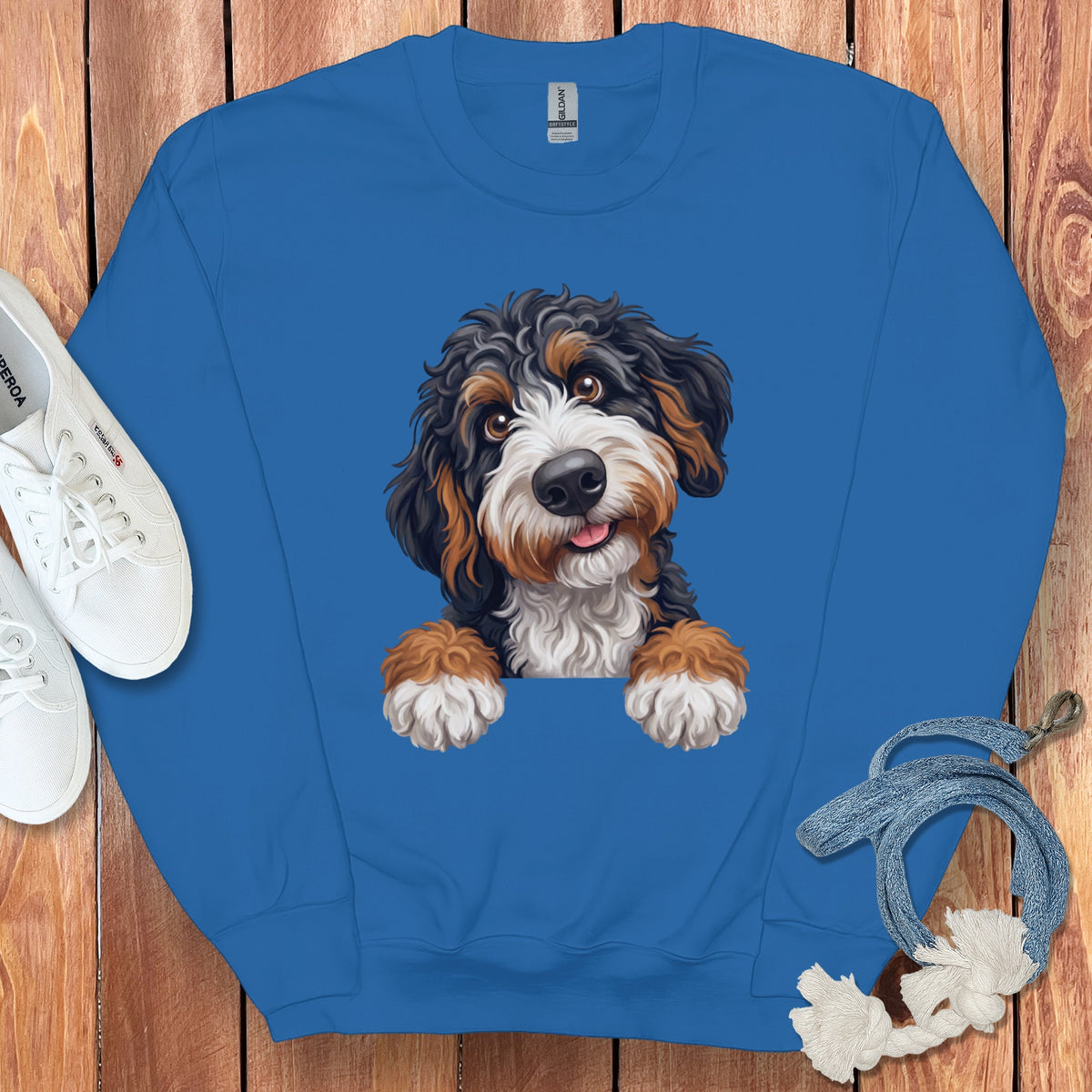 Blue sweatshirt with a graphic of a Bernese Mountain Dog puppy peeking over the neckline.