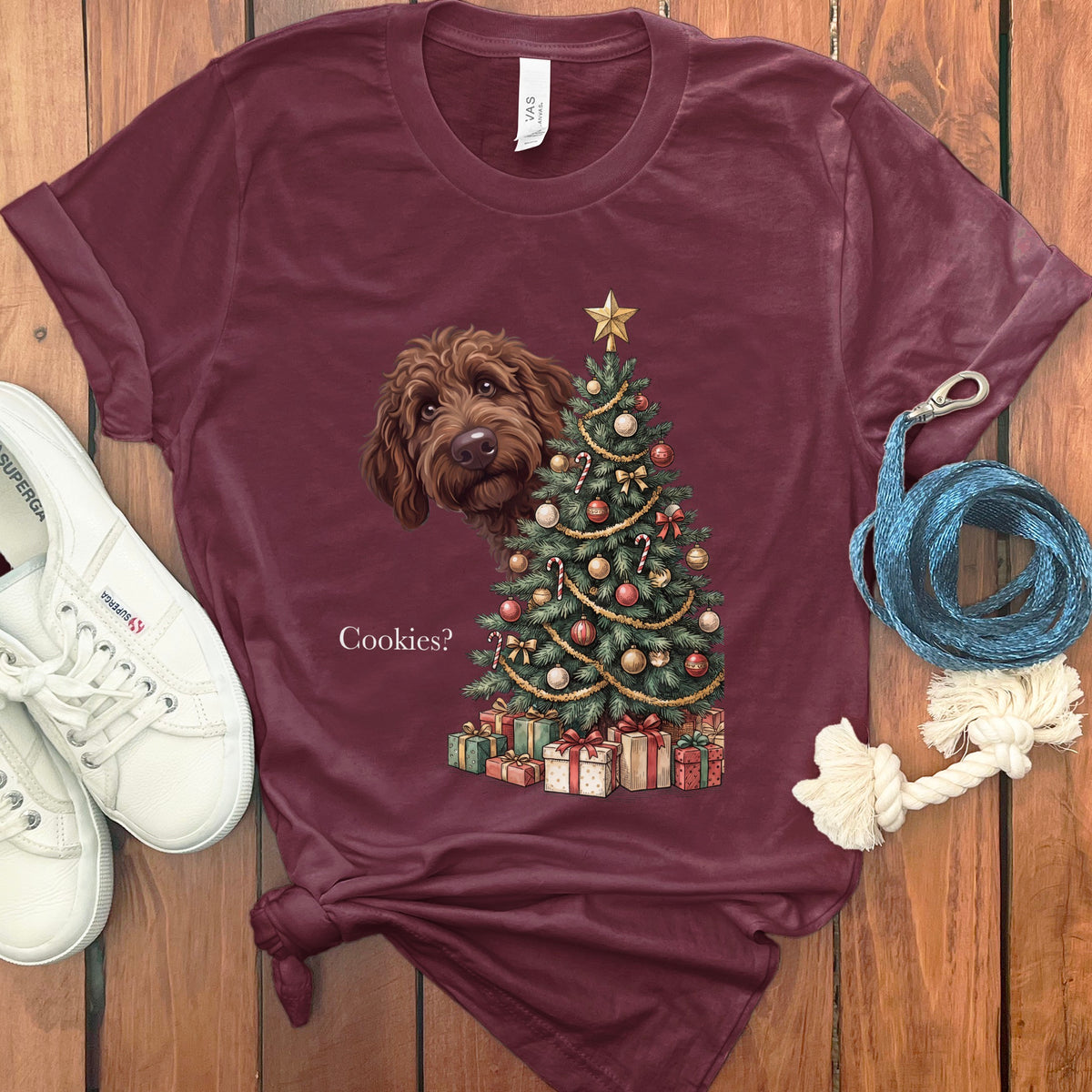 Maroon t-shirt with a doodle dog, Christmas tree, and presents graphic that says "Cookies?"