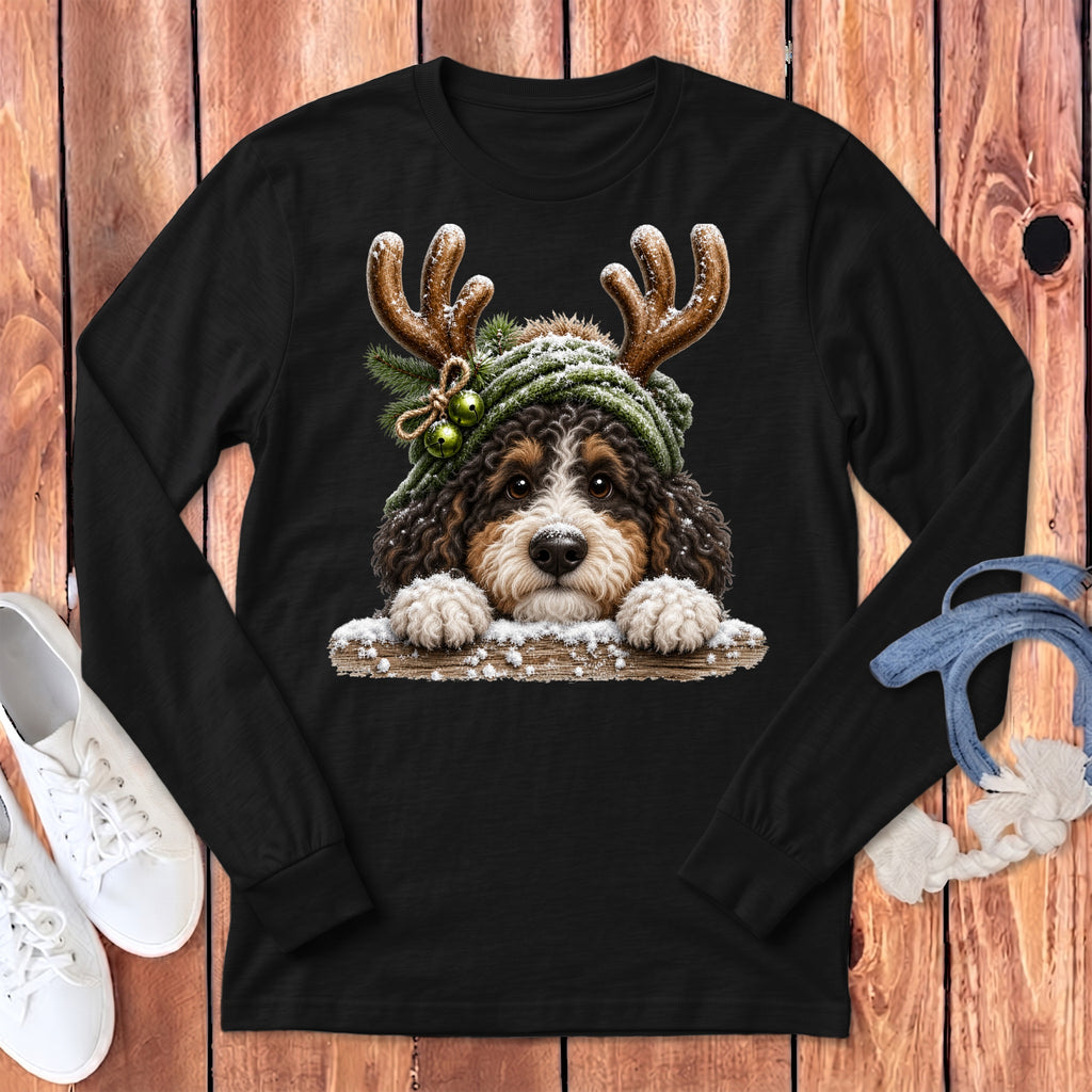 Bernese Mountain Dog wearing reindeer antlers and a green scarf with bells and snow.
