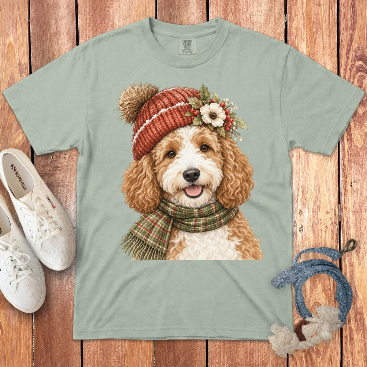 T-shirt with a painted doodle dog wearing a winter hat and scarf.
