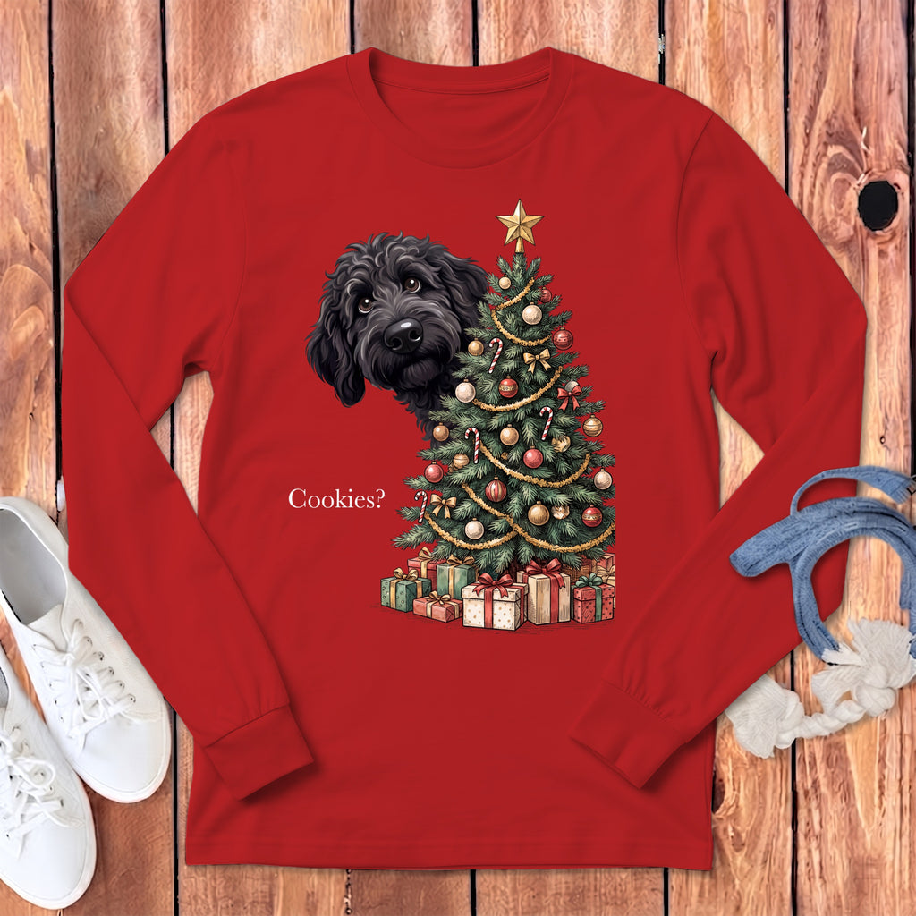 Black dog peeks from behind a decorated Christmas tree with presents and text "Cookies?".
