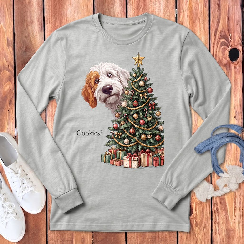Dog peering from behind Christmas tree with gifts and "Cookies?" text.