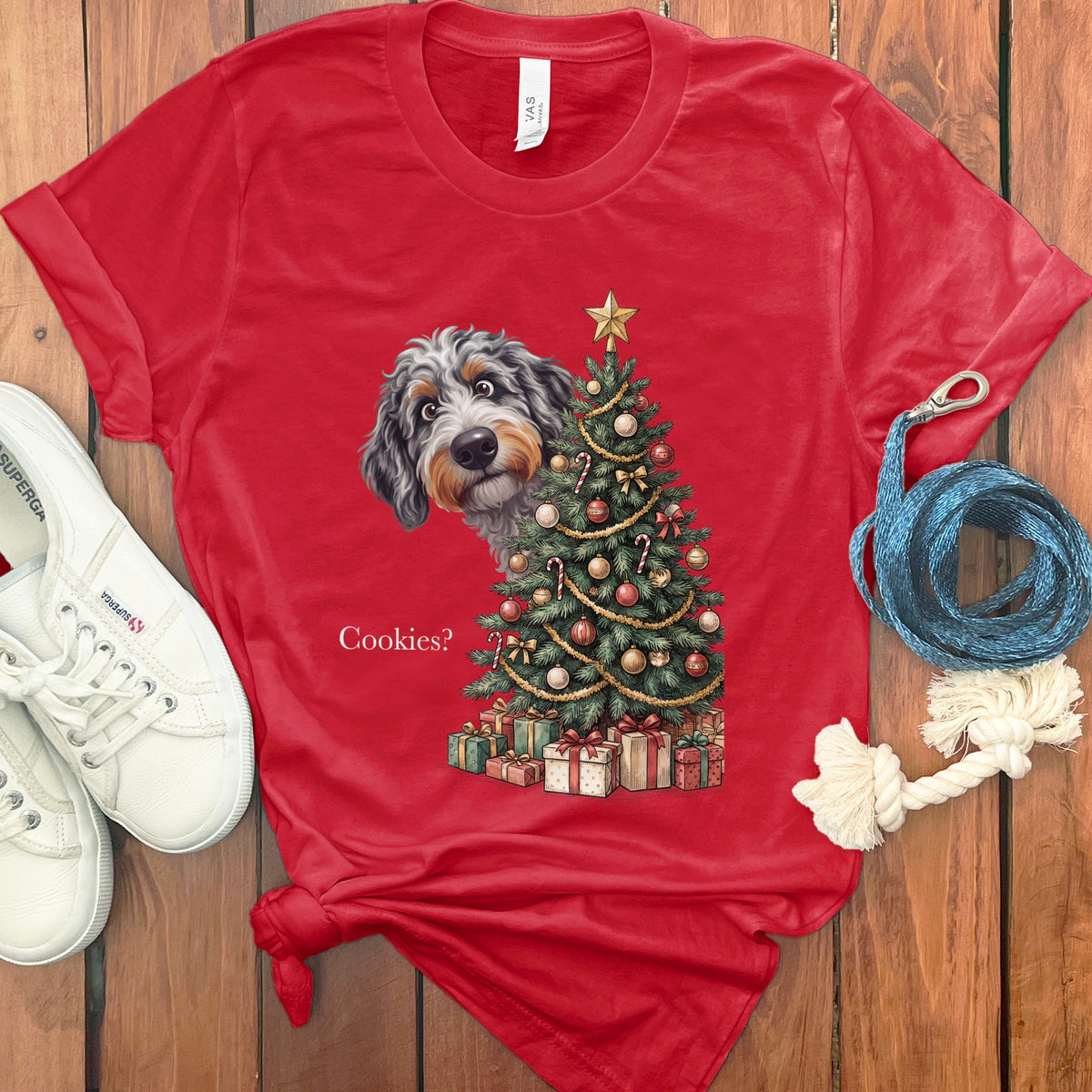 Red t-shirt with dog peering over Christmas tree and presents, text "Cookies?".