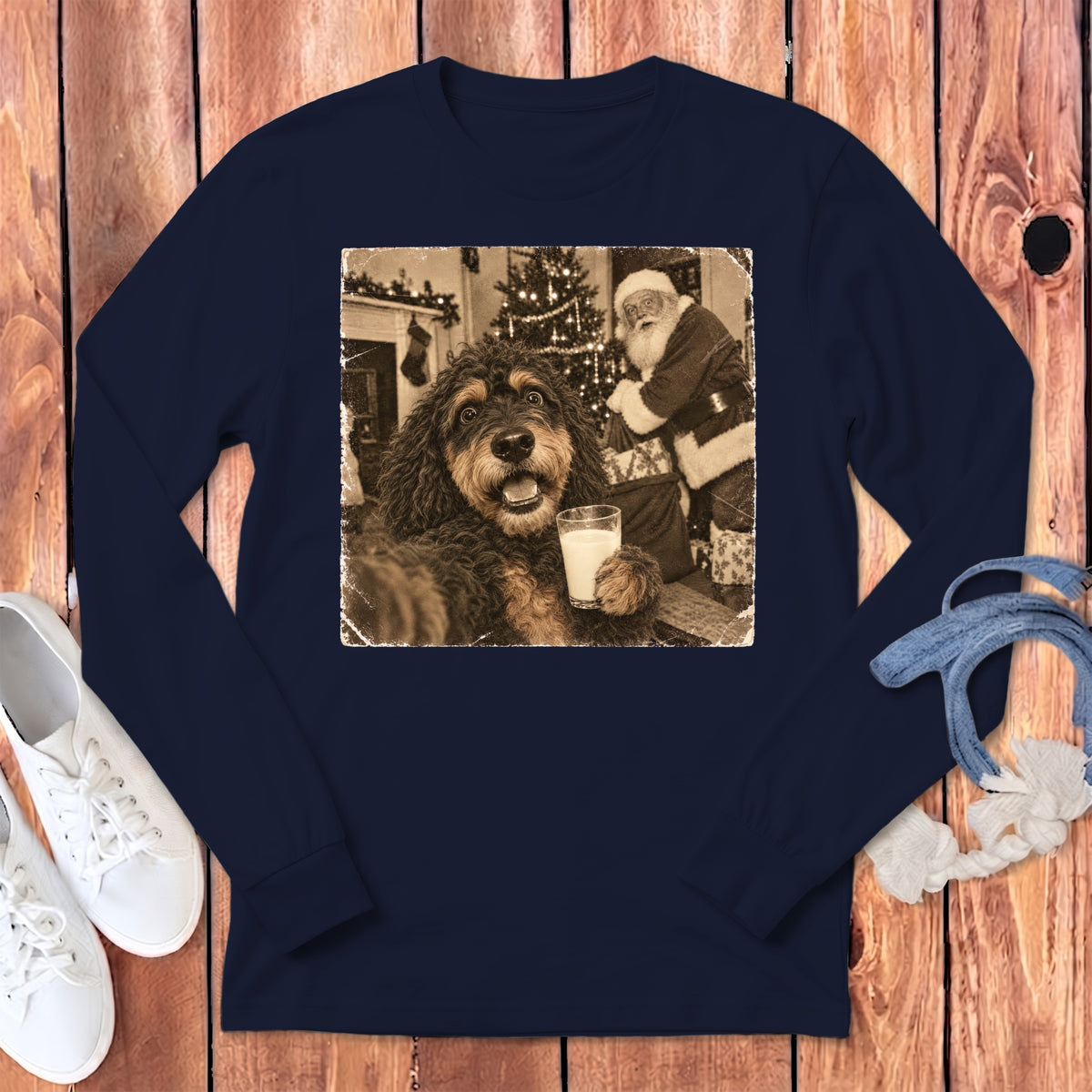 Navy long-sleeve t-shirt featuring a sepia-toned graphic of a fluffy dog holding a glass of milk with Santa Claus in the background.