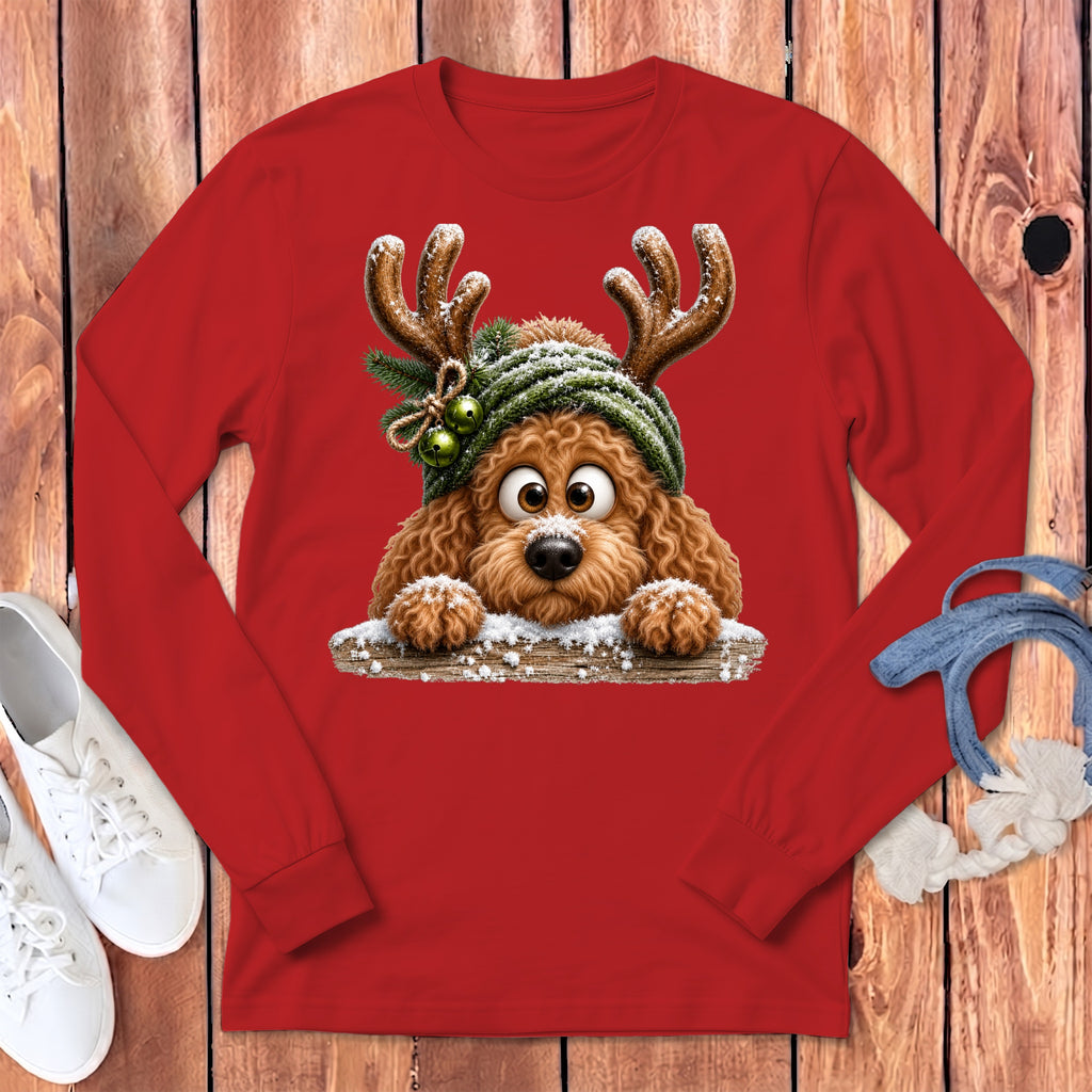 Fluffy dog wearing reindeer antlers and hat on red long-sleeve shirt.