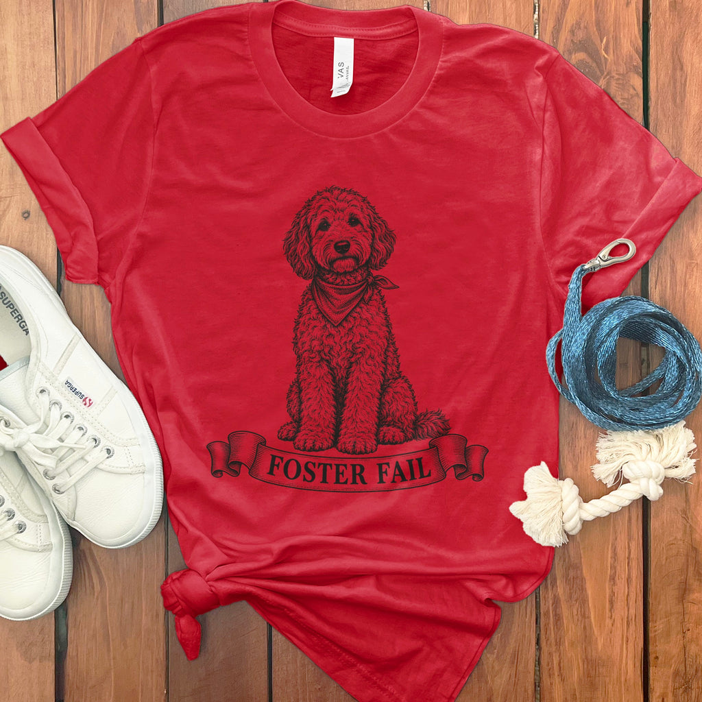 Red t-shirt with a doodle dog wearing a bandana and the text "Foster Fail".