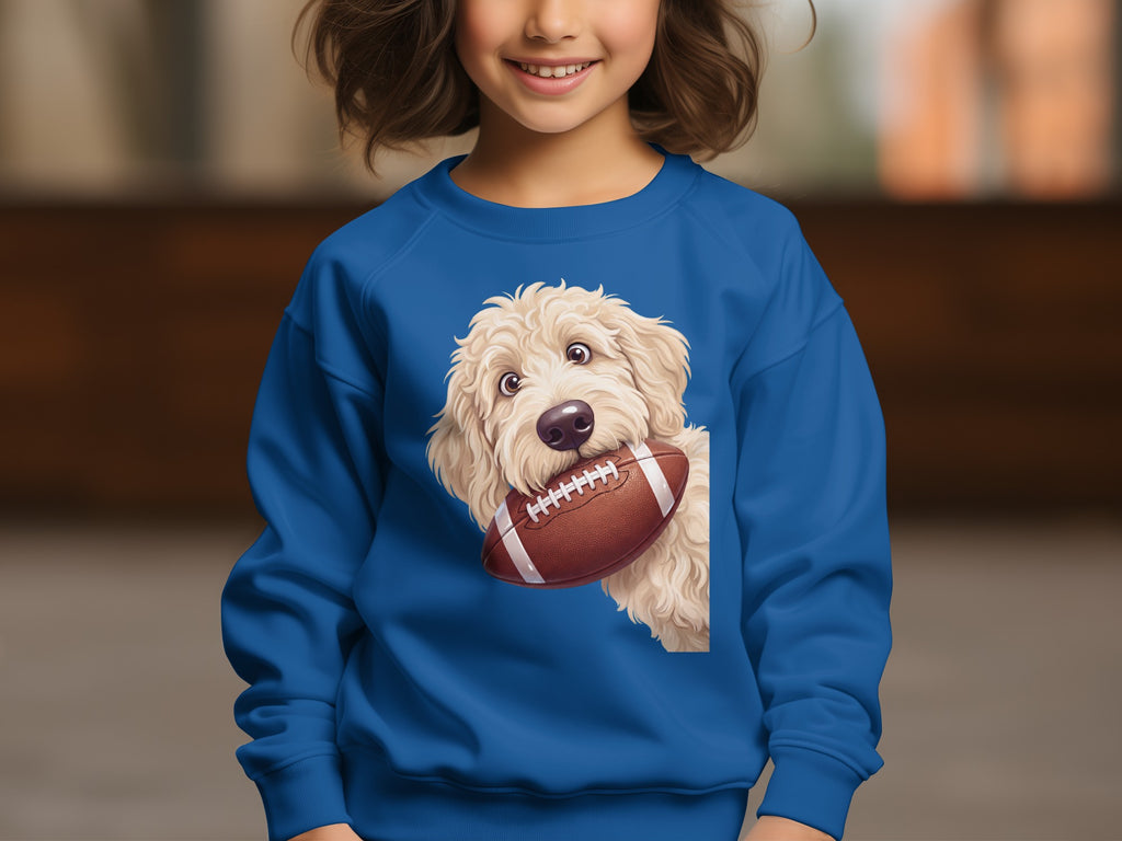Blue sweatshirt with a cream doodle dog holding a football.