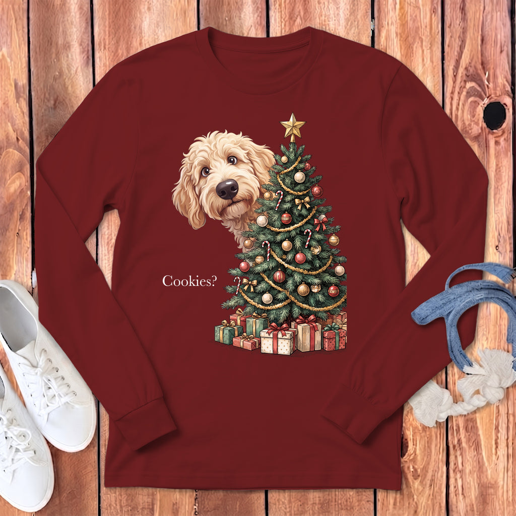 Goldendoodle peeking behind Christmas tree with gifts, text "Cookies?".
