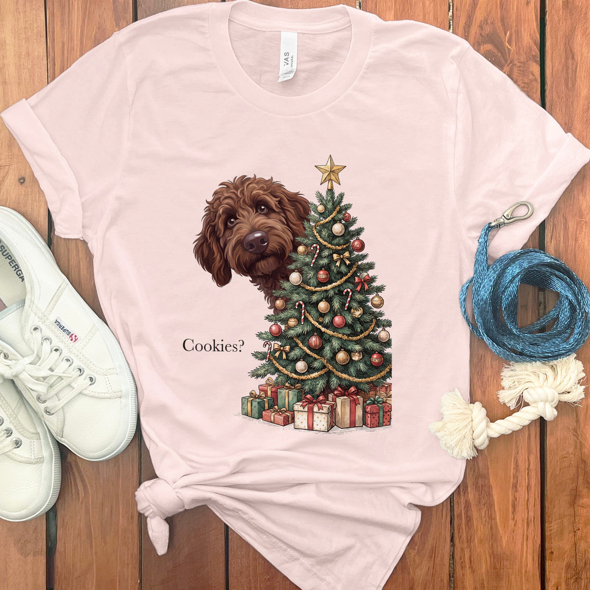Brown dog peeking from behind a Christmas tree with presents and the text "Cookies?".