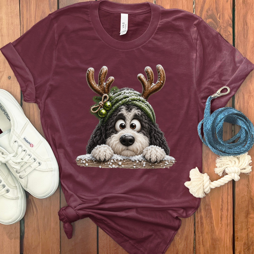 Maroon t-shirt with a cartoon dog wearing reindeer antlers and a green hat.