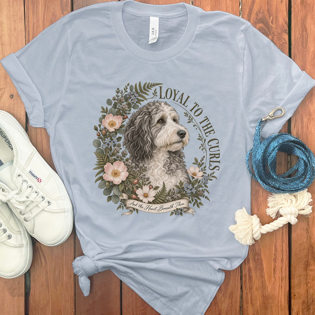 Light blue t-shirt with a doodle dog surrounded by flowers and text.