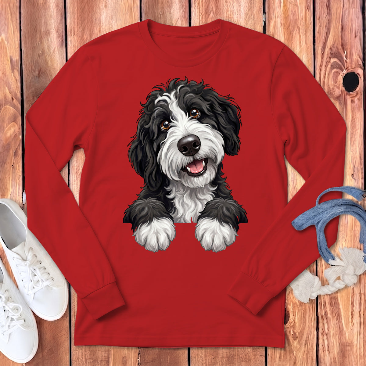Red long-sleeved shirt with a black and white dog illustration.
