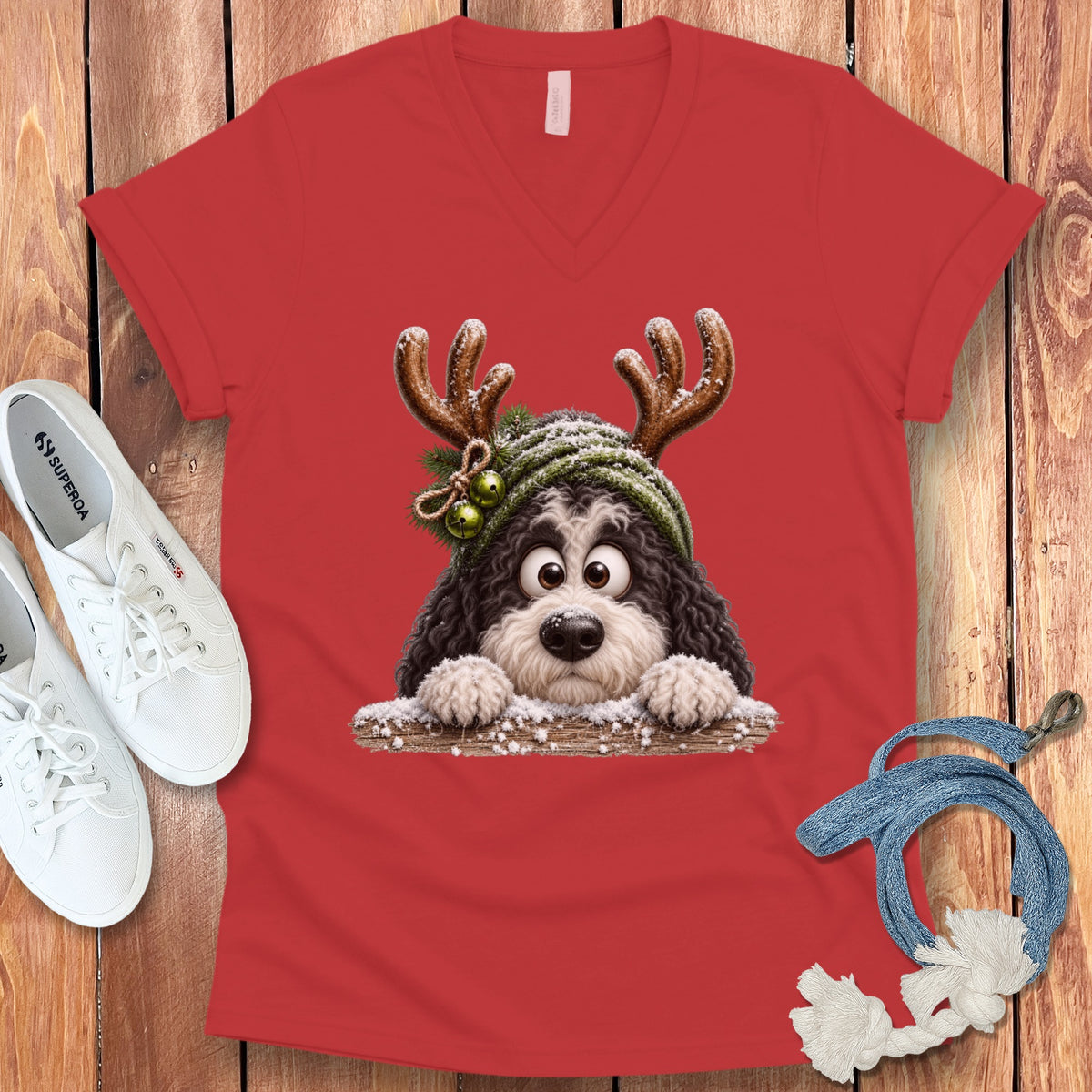 Red v-neck shirt featuring a cartoon dog with antlers and a winter hat.