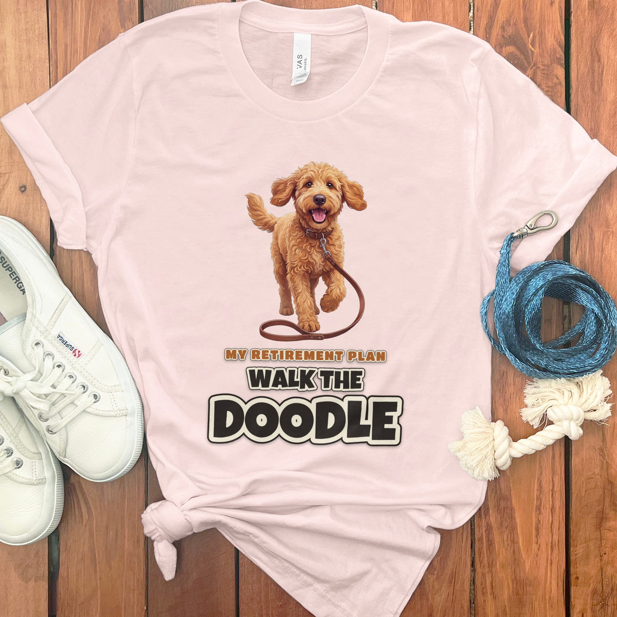 Pink t-shirt with a doodle dog graphic and text "MY RETIREMENT PLAN WALK THE DOODLE".