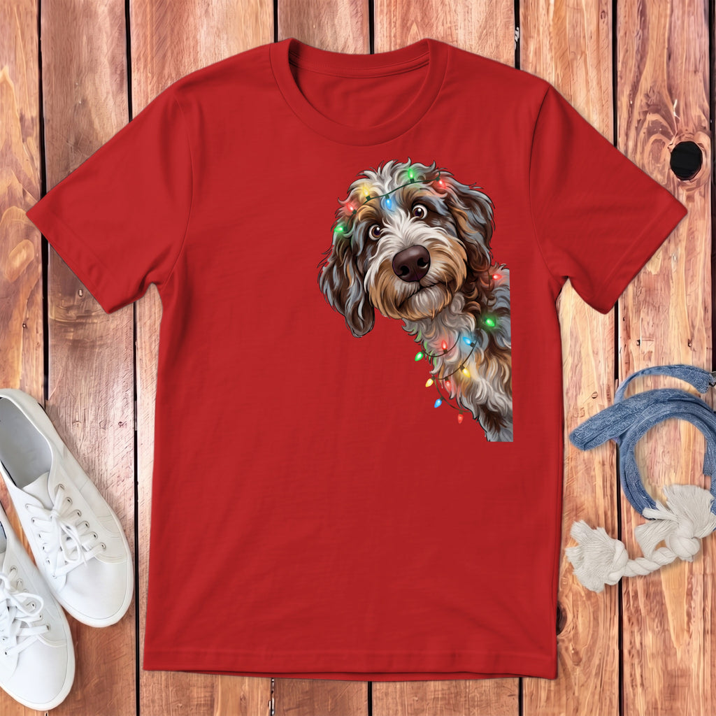 Red t-shirt with a cartoon dog peeking out, wrapped in colorful Christmas lights.