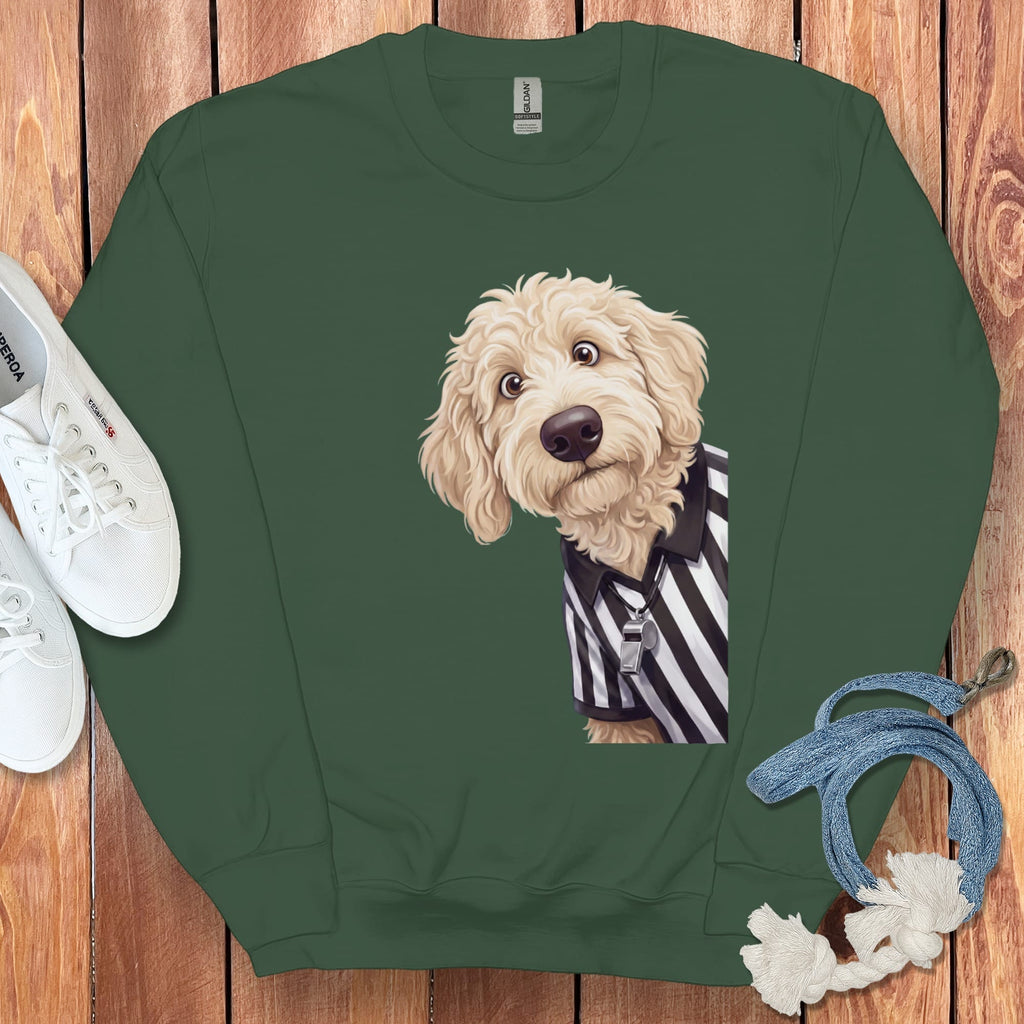 Fluffy dog in referee uniform with a whistle on a dark green sweatshirt.