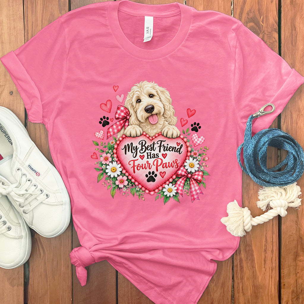 A pink t-shirt featuring a goldendoodle graphic, hearts, flowers, and the text My Best Friend Has Four Paws.