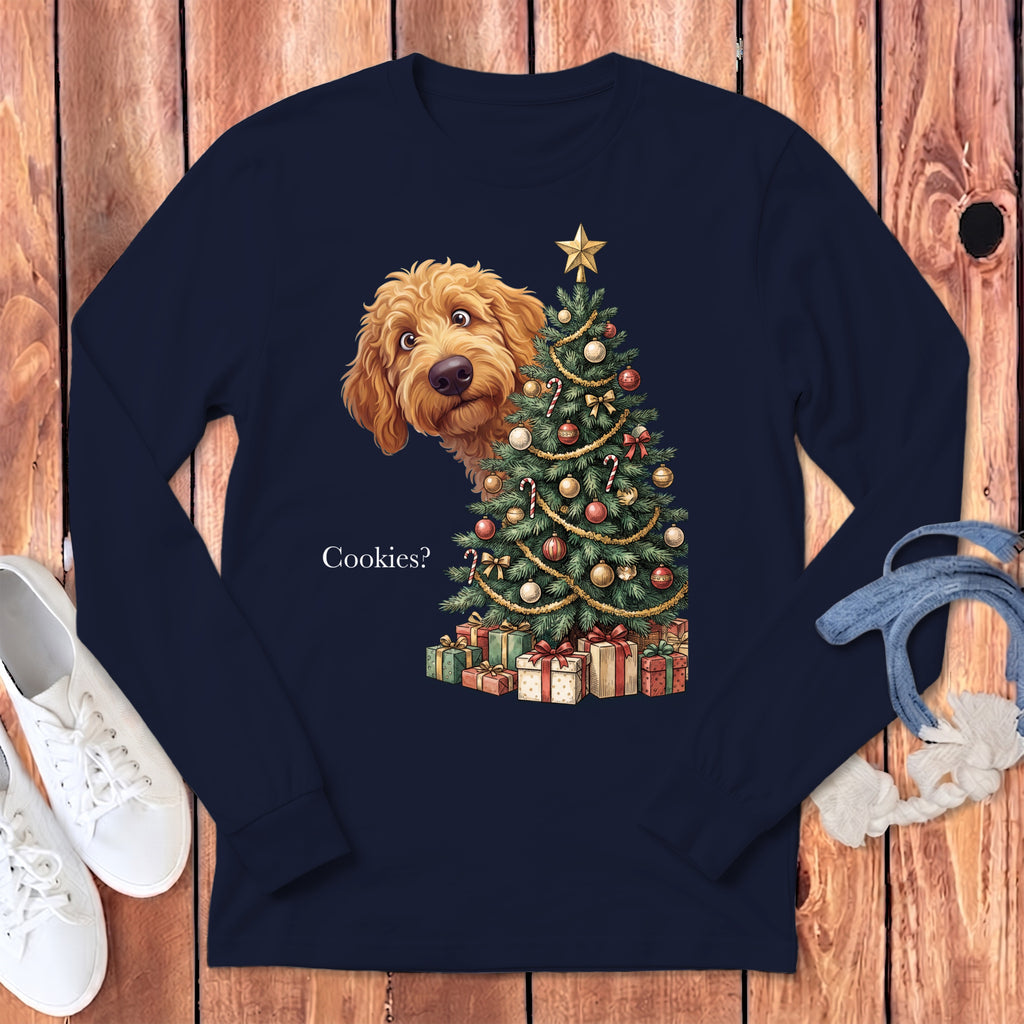 Goldendoodle peeking from behind a decorated Christmas tree and presents, with text "Cookies?".