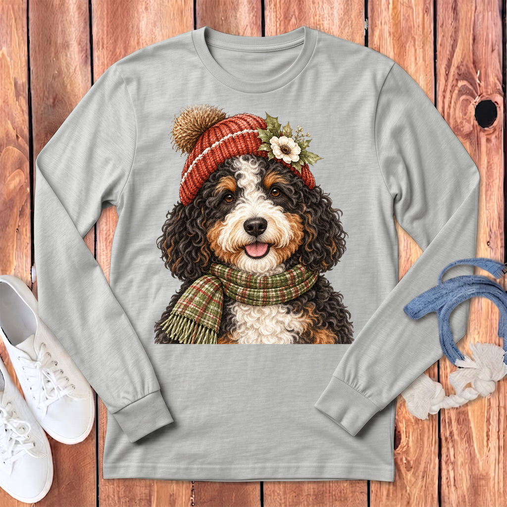 Bernese Mountain Dog wearing a winter hat and scarf, graphic on a grey long-sleeve shirt.