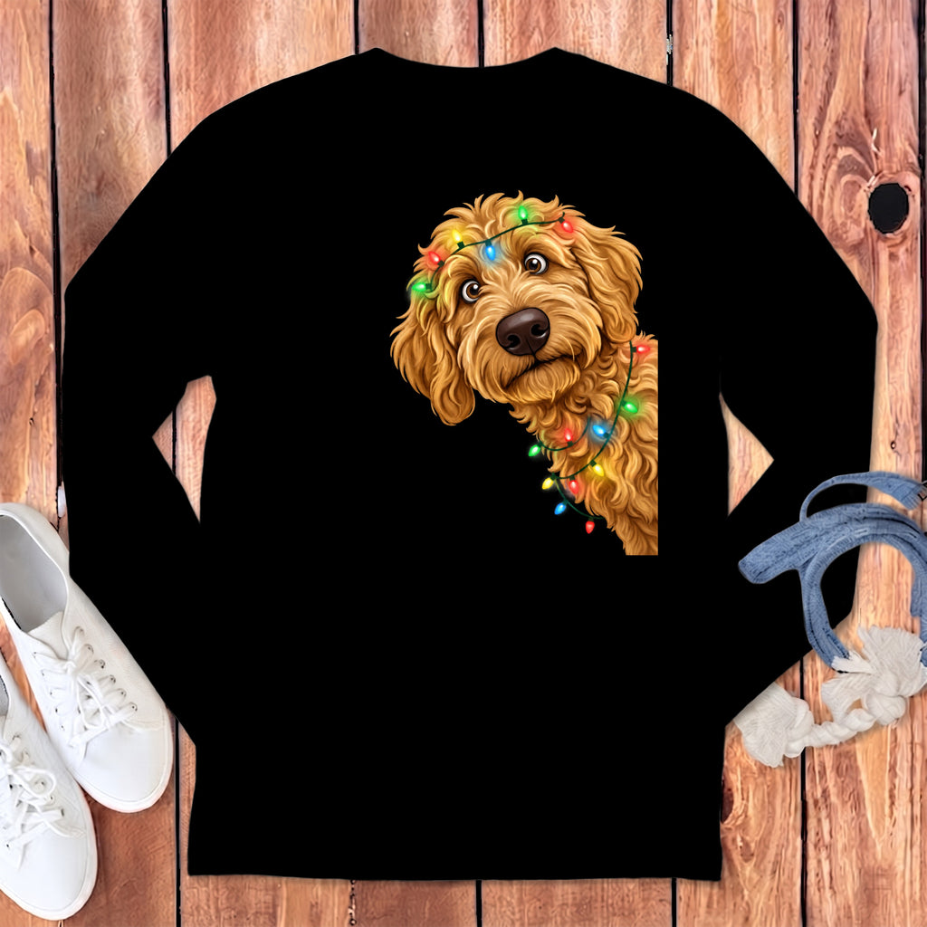 Goldendoodle dog wearing colorful Christmas lights peeking from black shirt.