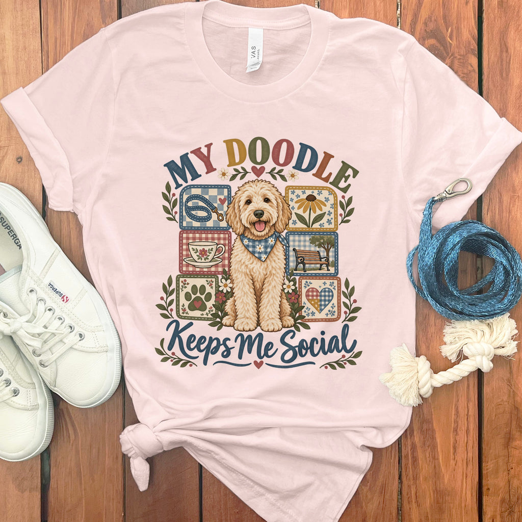 Pink t-shirt with a doodle dog graphic and text "MY DOODLE Keeps Me Social".