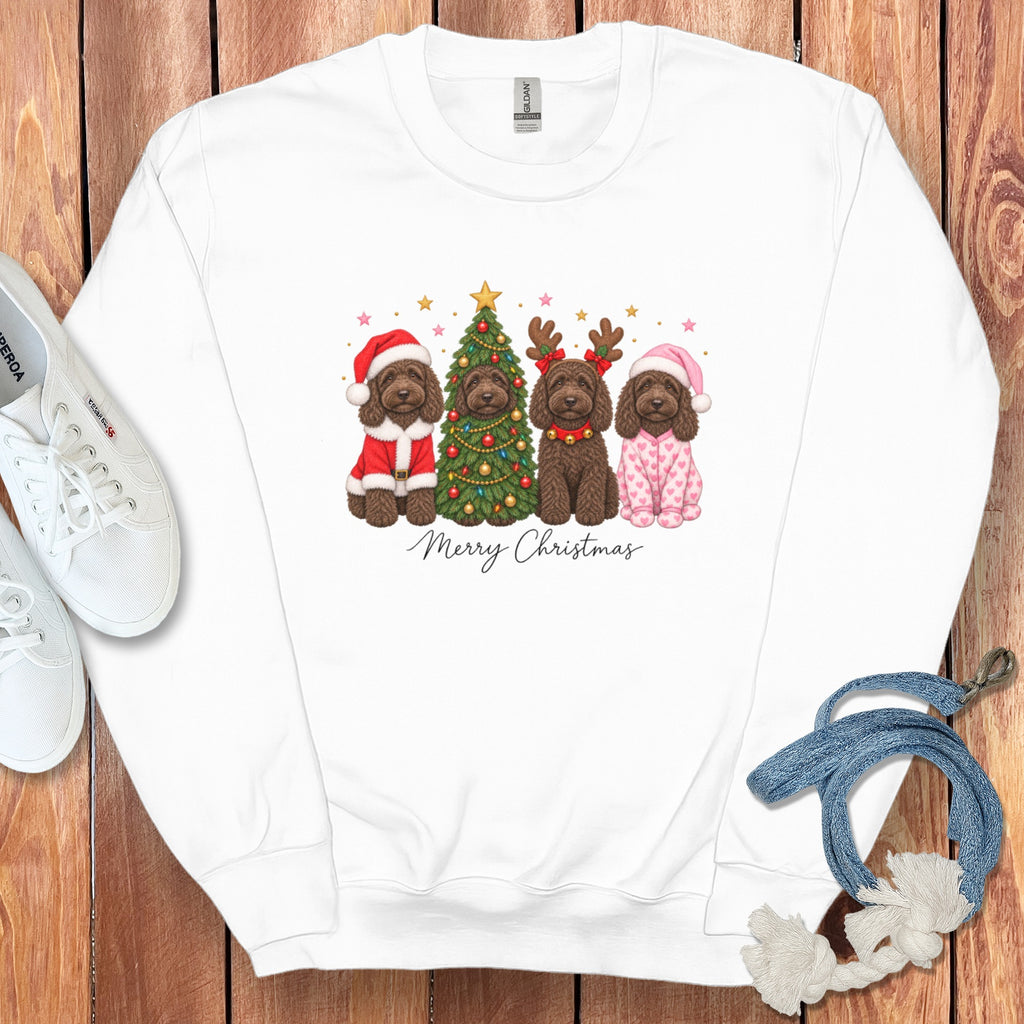 White crewneck sweatshirt featuring a graphic of four brown dogs in Christmas attire surrounding a decorated tree.