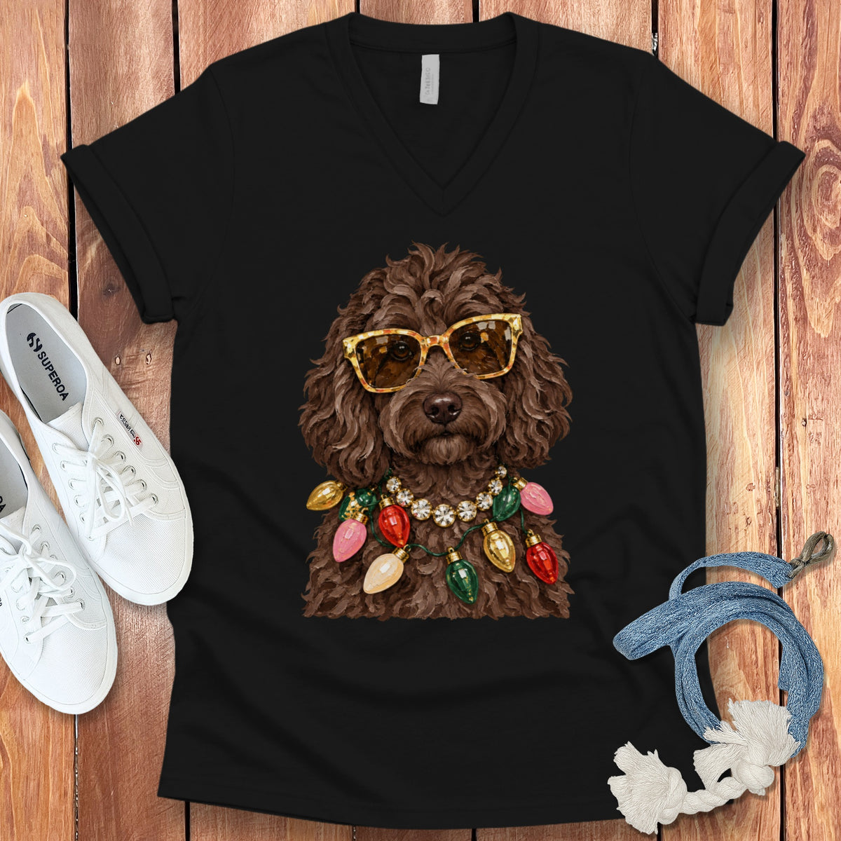 Brown poodle wearing sunglasses and a colorful Christmas light necklace.