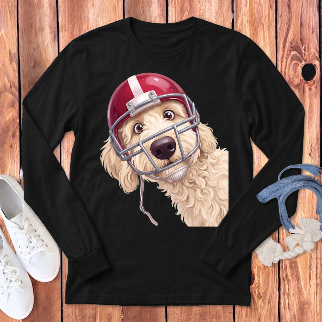 Cream colored dog wearing a red and white football helmet on a black long sleeve shirt.