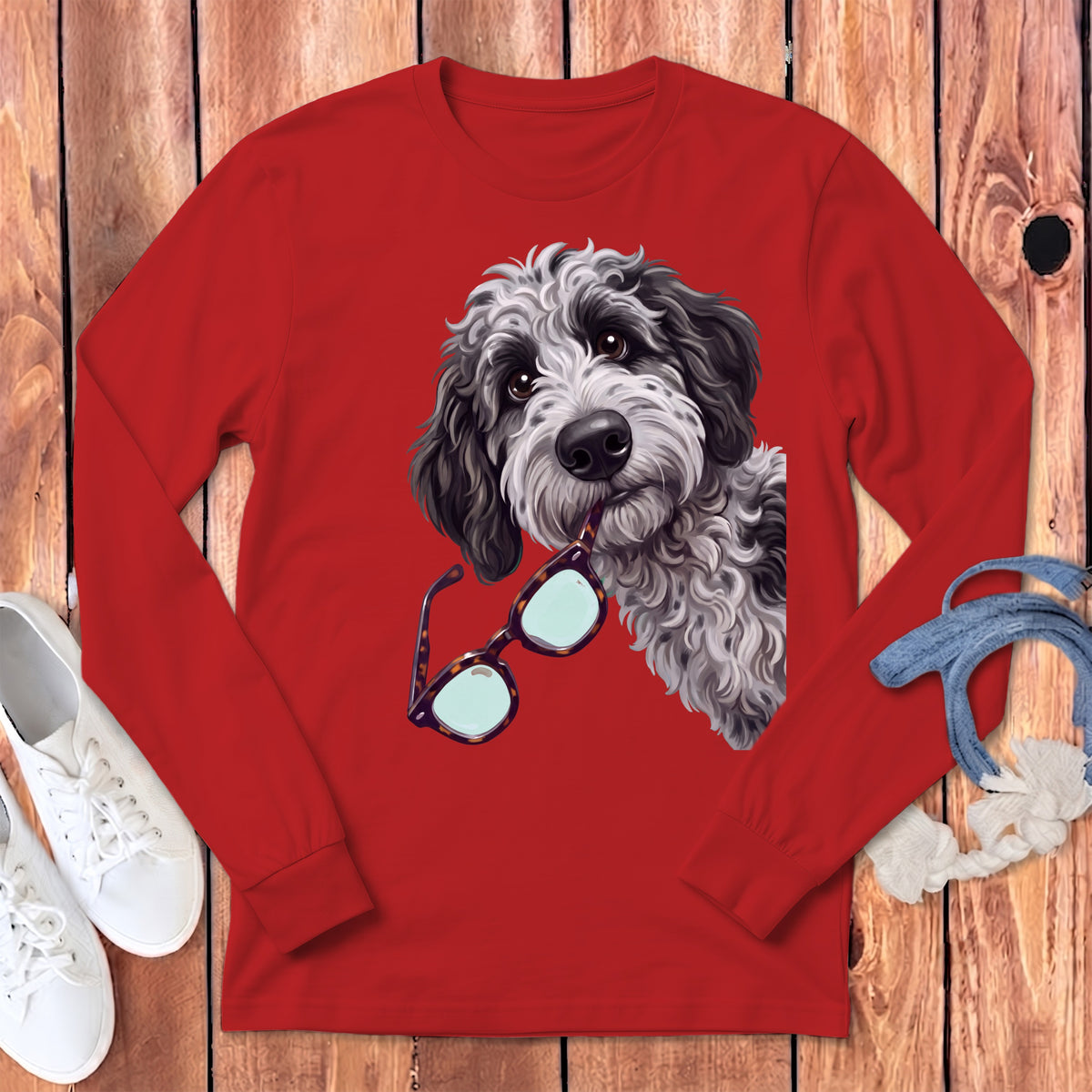 A red long-sleeve t-shirt with a graphic of a shaggy doodle dog holding glasses.