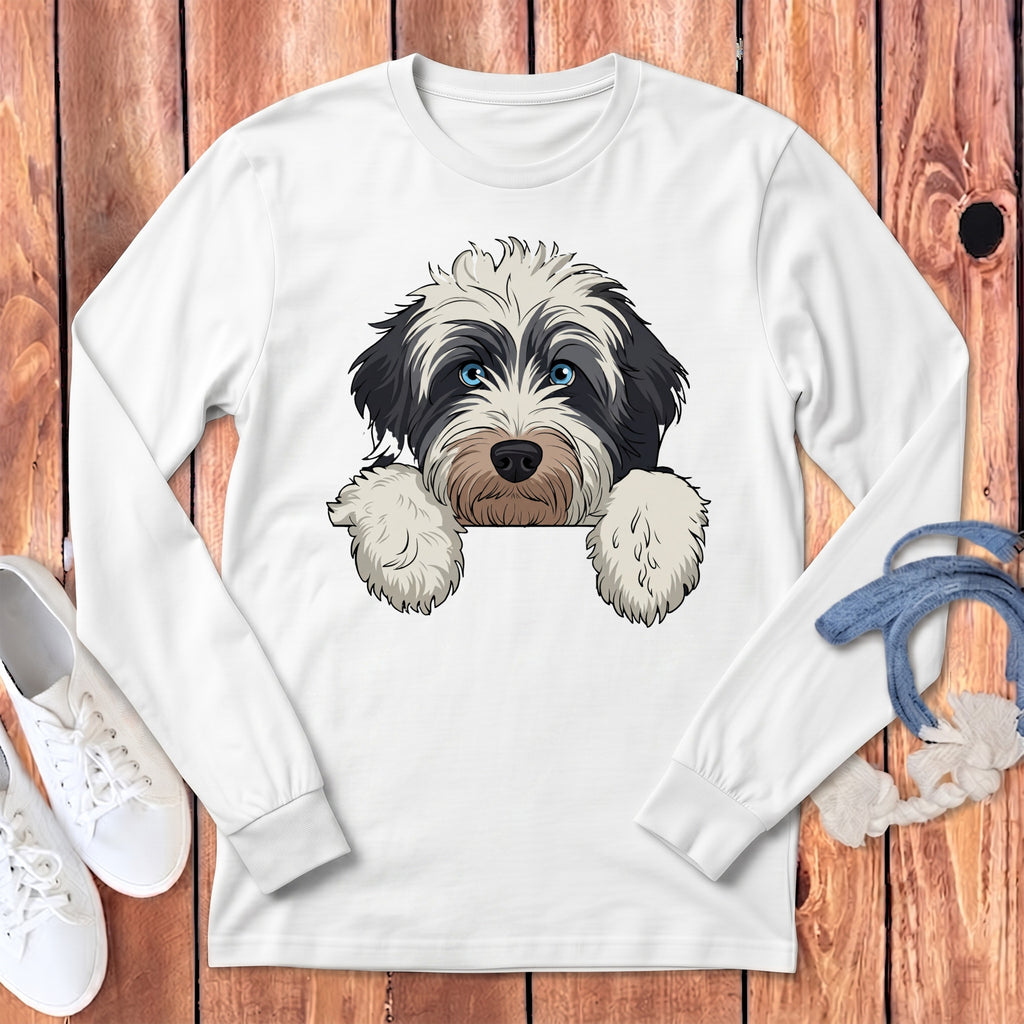 White long-sleeve shirt featuring a black and white shaggy dog graphic with blue eyes.