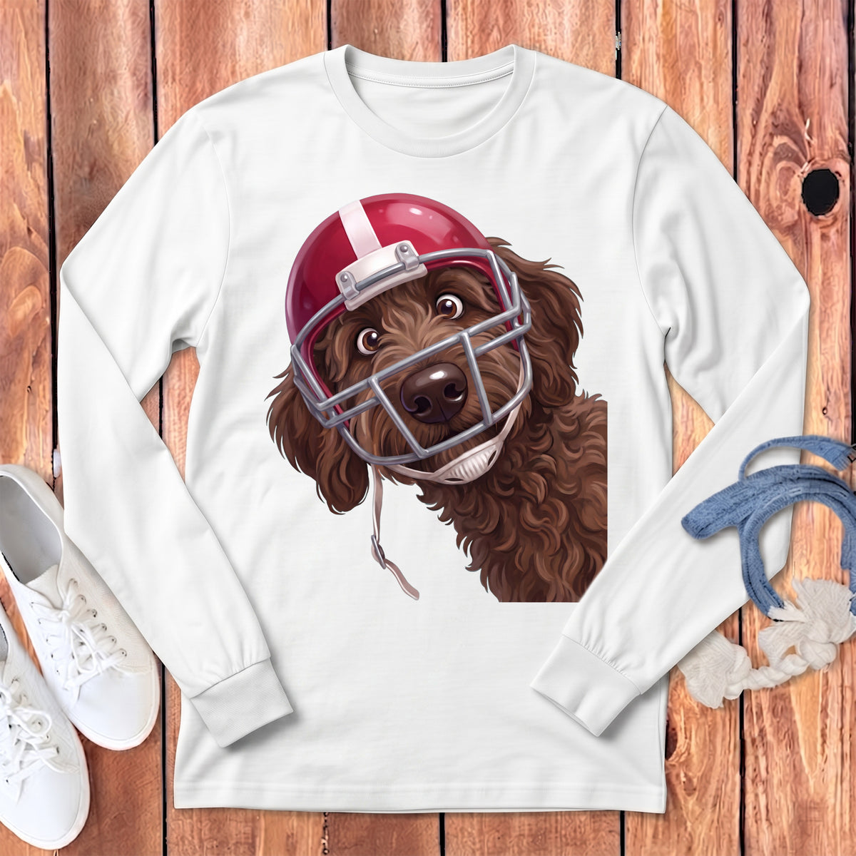 Brown doodle dog wearing a red football helmet and facemask, on a white shirt.