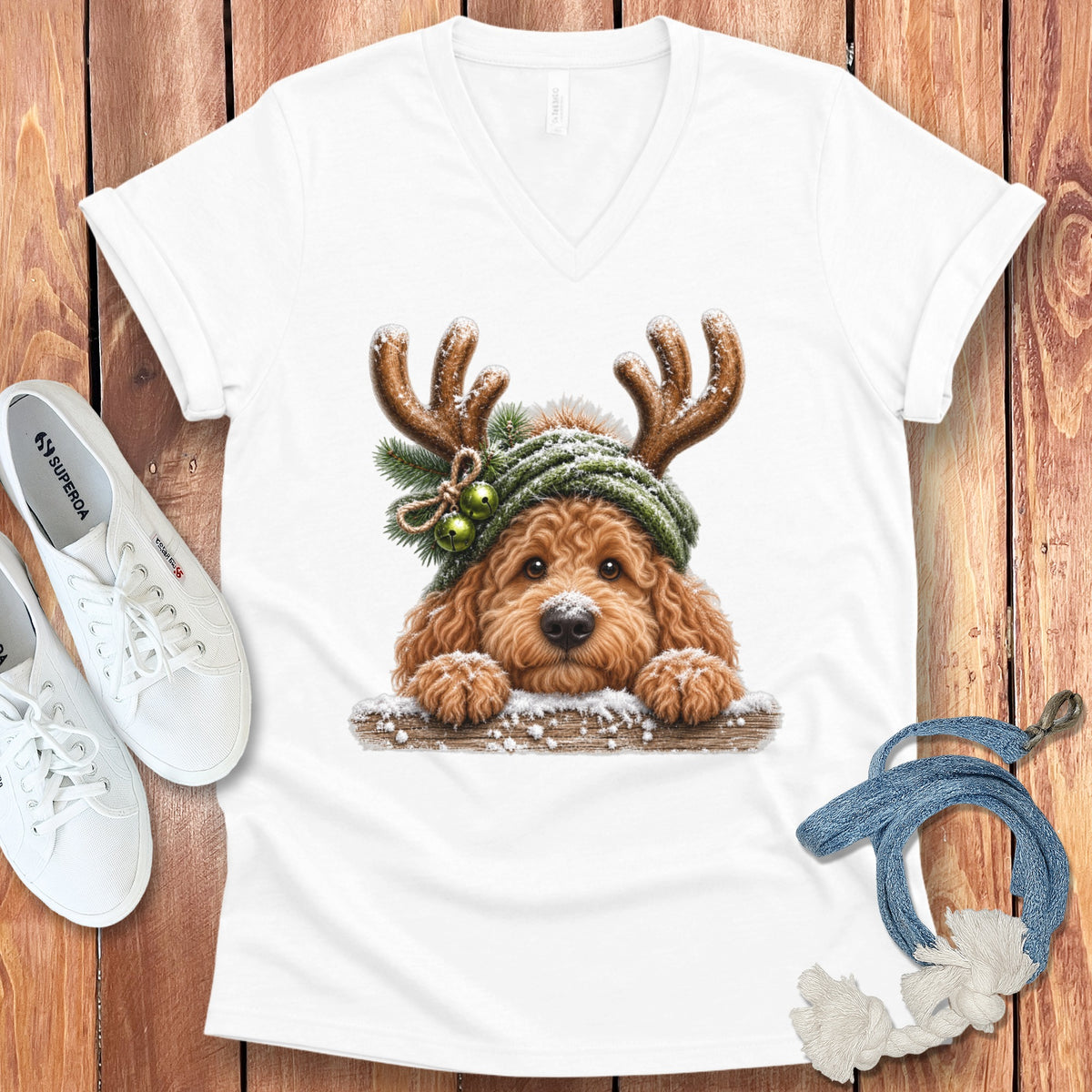 White v-neck t-shirt with a Christmas dog graphic wearing antlers and a hat.