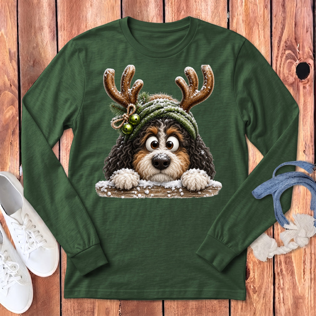 Green long sleeve shirt with a cartoon dog wearing reindeer antlers and a winter hat.