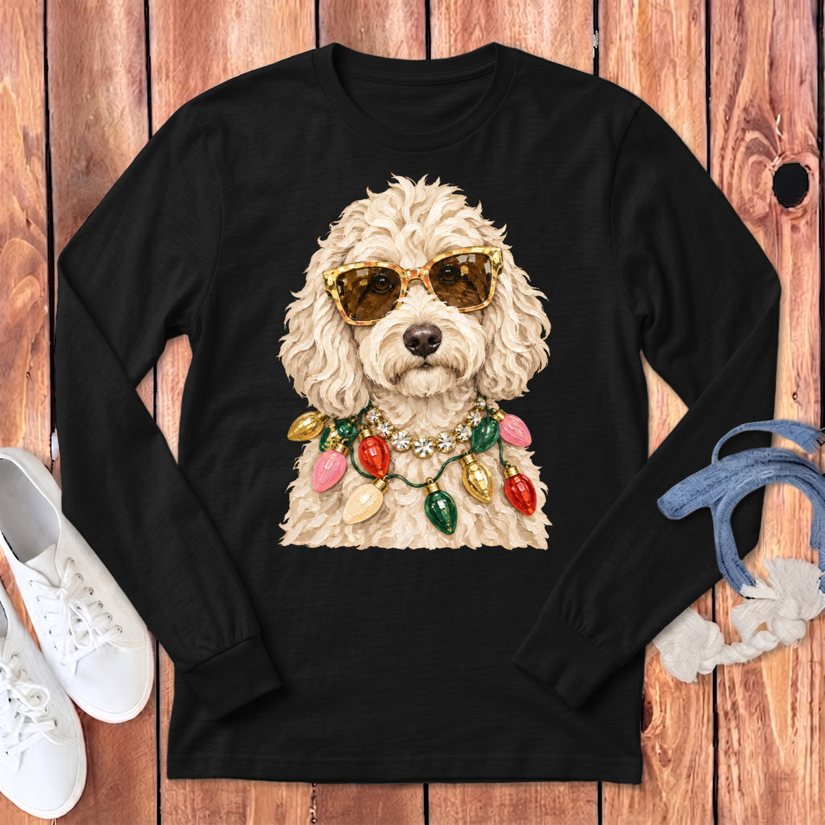 Fluffy dog wearing sunglasses and a Christmas light necklace on a black shirt.