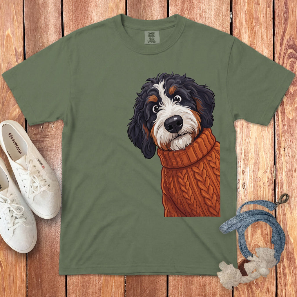 Green t-shirt with illustration of Bernese Mountain Dog puppy in an orange sweater.