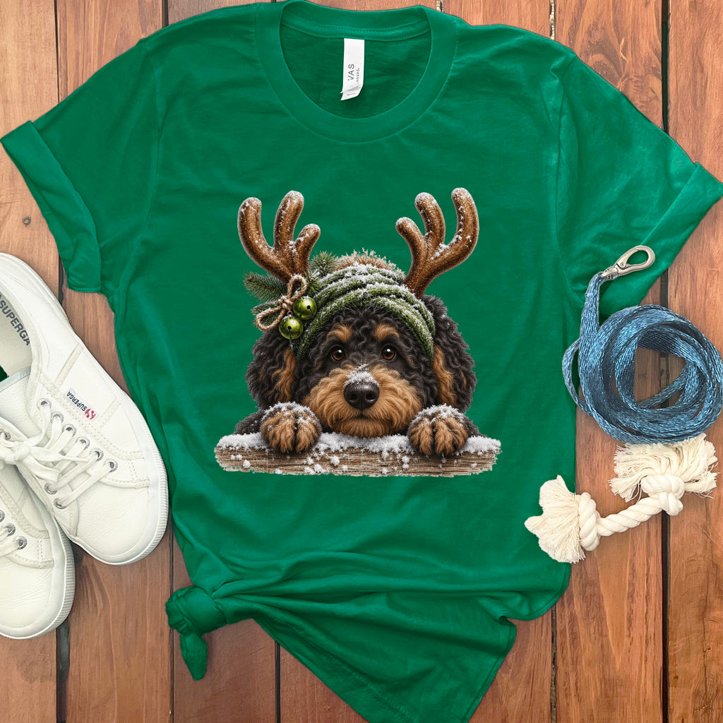 Green t-shirt with a fluffy dog wearing antlers and a knit hat.