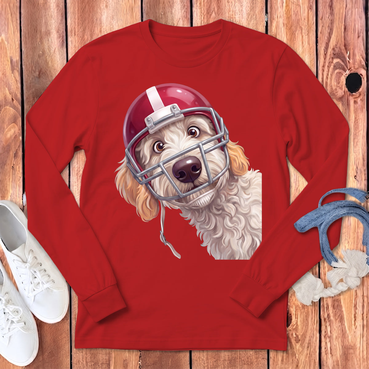Goldendoodle dog wearing a red football helmet with face mask.