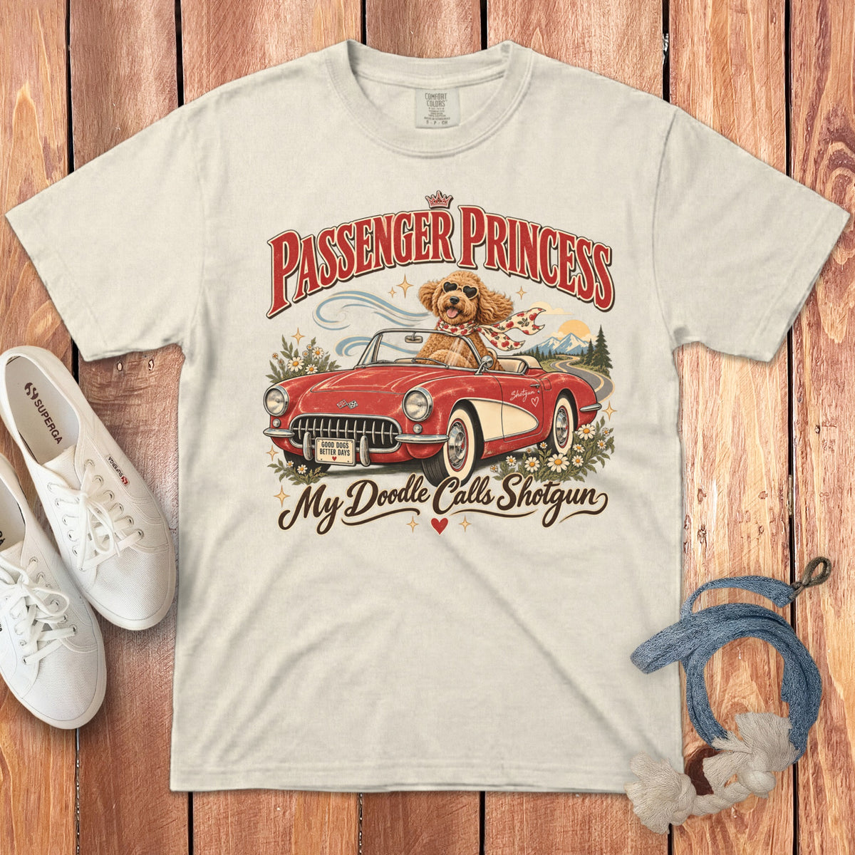 Cream t-shirt with a vintage graphic of a dog in a red convertible, reading "Passenger Princess" and "My Doodle Calls Shotgun".