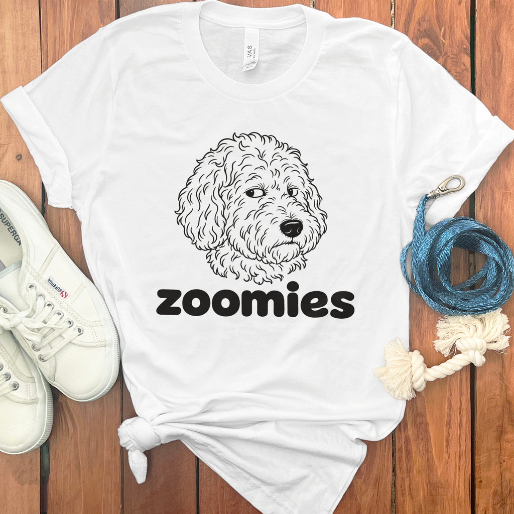 White t-shirt with line drawing of a dog's face and the word "zoomies".