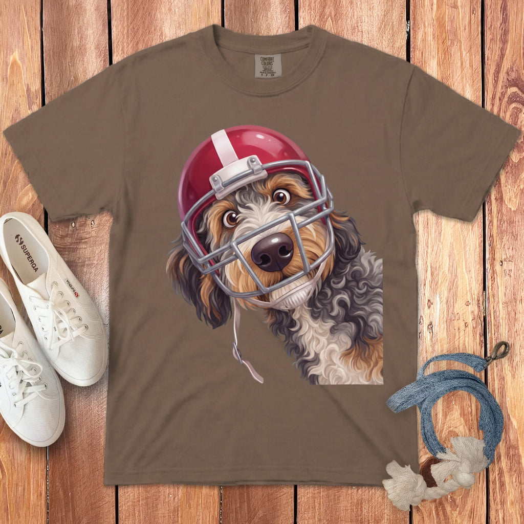 Brown t-shirt with a doodle dog wearing a red football helmet and face mask.