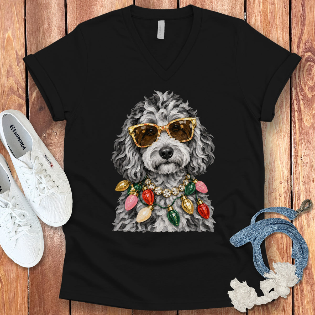 Black t-shirt with a watercolor print of a dog wearing sunglasses and Christmas lights.