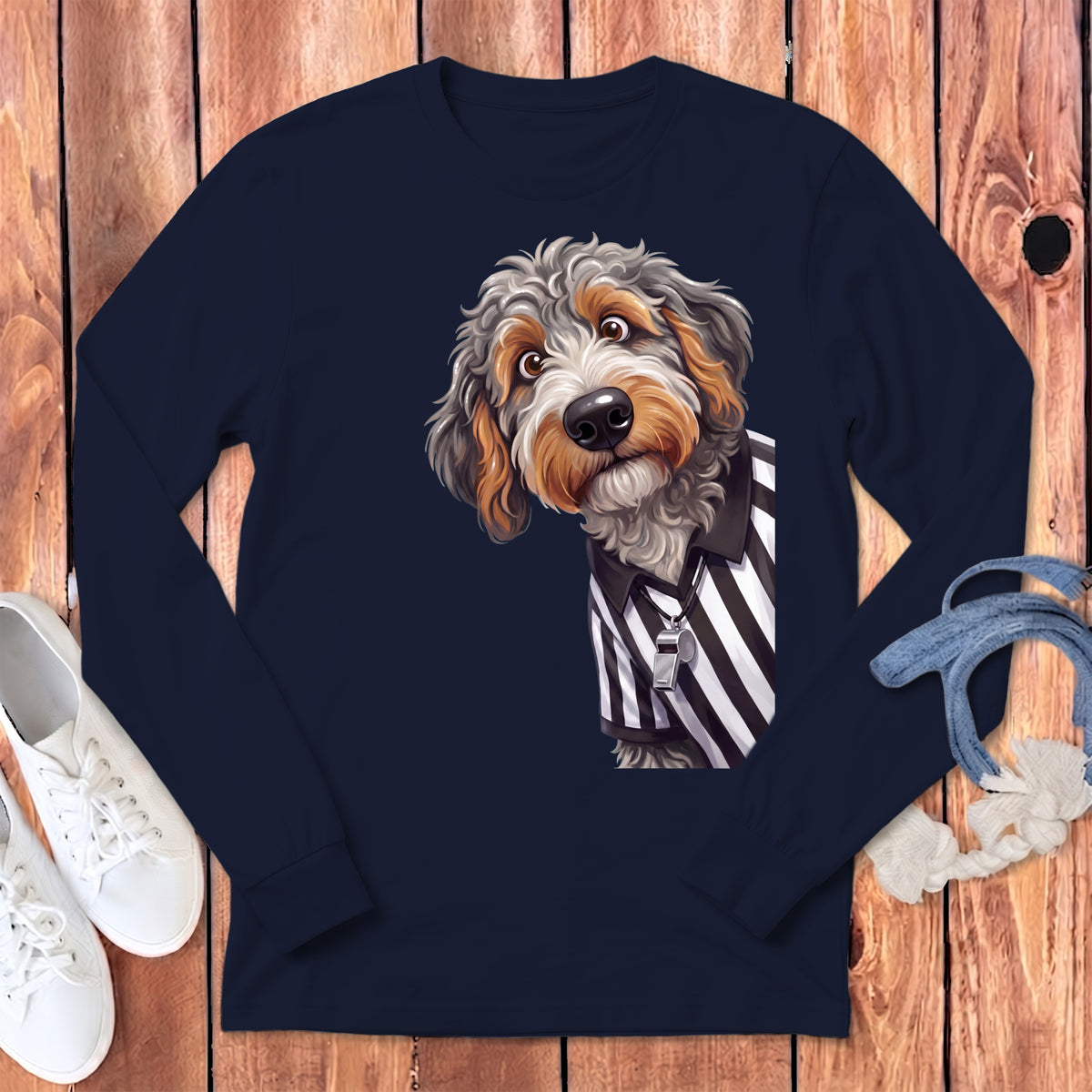 Doodle dog wearing a referee shirt and whistle, shown on a navy long-sleeve shirt.
