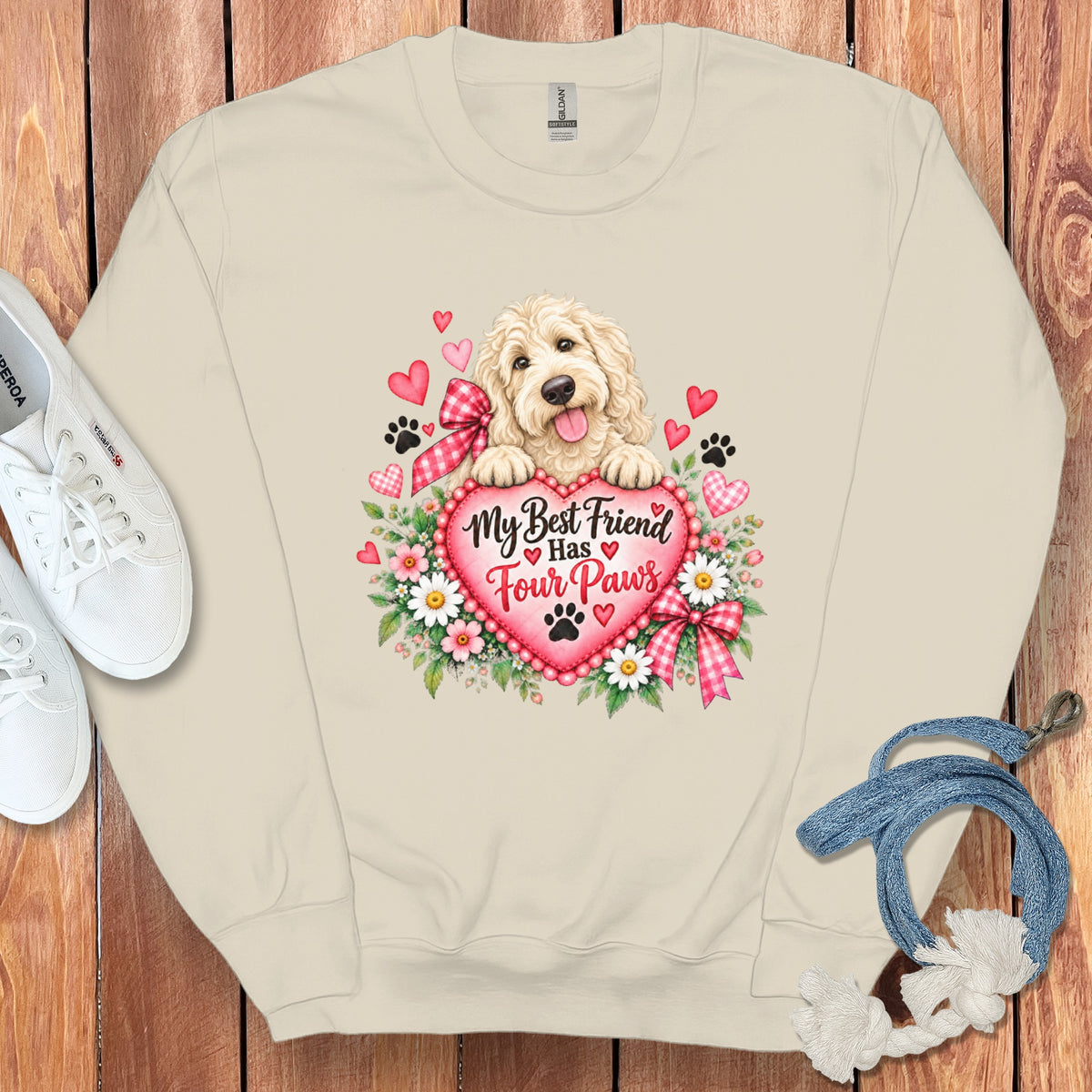 Beige crewneck sweatshirt featuring a graphic of a golden doodle resting on a heart with the text My Best Friend Has Four Paws.